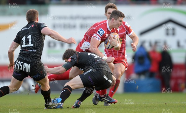 261213 - Scarlets v Ospreys - RaboDirect PRO12 -Scott Williams of Scarlets is tackled by Dan Biggar of Ospreys