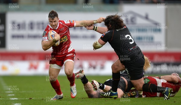 261213 - Scarlets v Ospreys - RaboDirect PRO12 -Gareth Davies of Scarlets holds off Adam Jones of Ospreys