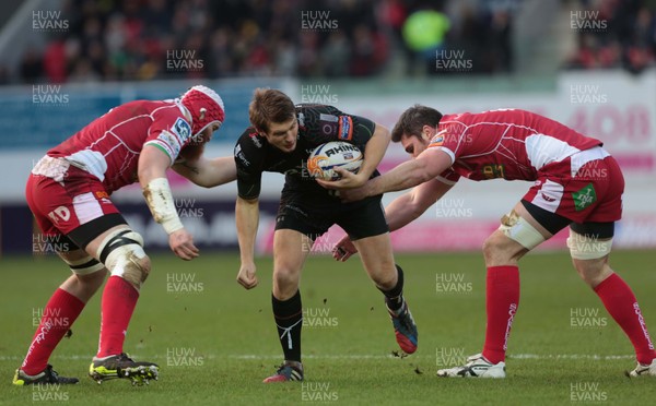 261213 - Scarlets v Ospreys - RaboDirect PRO12 -Dan Biggar of Ospreys is tackled by Jake Ball and Rob McCusker of Scarlets