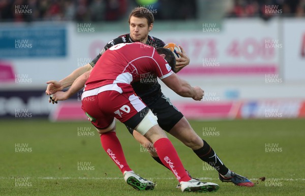 261213 - Scarlets v Ospreys - RaboDirect PRO12 -Dan Biggar of Ospreys is tackled by Rob McCusker of Scarlets