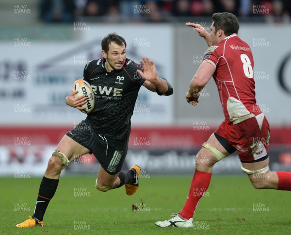 261213 - Scarlets v Ospreys - RaboDirect PRO12 -Joe Bearman of Ospreys takes on Rob McCusker