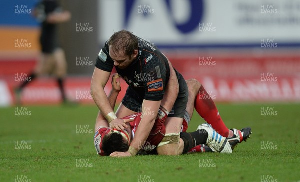 261213 - Scarlets v Ospreys - RaboDirect PRO12 -Alun Wyn Jones of Ospreys and Emyr Phillips of Scarlets have an exchange