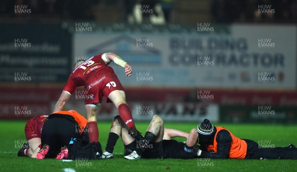 261217 - Scarlets v Ospreys - Guinness PRO14 - Ben John of Ospreys and Steff Evans of Scarlets are treated after colliding in the air