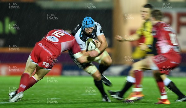 261219 - Scarlets v Ospreys - Guinness PRO14 - Justin Tipuric of Ospreys is tackled by Hadleigh Parkes of Scarlets