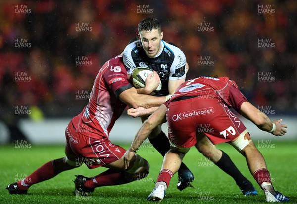 261219 - Scarlets v Ospreys - Guinness PRO14 - Tom Williams of Ospreys is tackled by Aaron Shingler and Josh Macleod of Scarlets