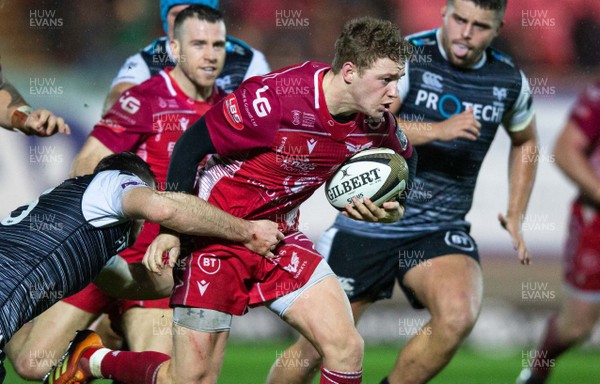 261219 - Scarlets v Ospreys - Guinness PRO14 - Angus O’Brien of Scarlets is tackled by Cai Evans