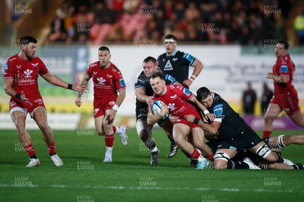 261223 - Scarlets v Ospreys - United Rugby Championship - Ioan Lloyd of Scarlets is tackled by Rhys Davies of Ospreys