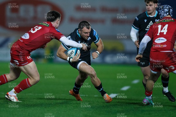 261223 - Scarlets v Ospreys - United Rugby Championship - Luke Morgan of Ospreys is tackled by Joe Roberts of Scarlets