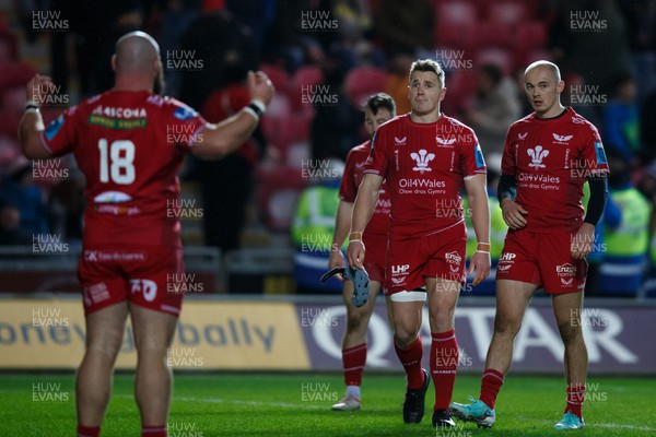 261223 - Scarlets v Ospreys - United Rugby Championship - Joe Jones, Jonathan Davies and Ioan Nicholas of Scarlets look despondent at the end of the match