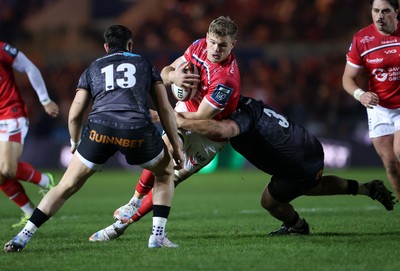 261225 - Scarlets v Ospreys - United Rugby Championship - Taine Plumtree of Scarlets is tackled by Rhys Henry of Ospreys 