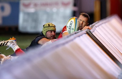 261225 - Scarlets v Ospreys - United Rugby Championship - Gareth Davies of Scarlets collides with the advertising boards