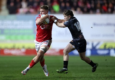 261225 - Scarlets v Ospreys - United Rugby Championship - Taine Plumtree of Scarlets is tackled by Dan Edwards of Ospreys 
