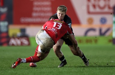 261225 - Scarlets v Ospreys - United Rugby Championship - Keiran Williams of Ospreys is tackled by Eddie James of Scarlets 