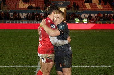 261225 - Scarlets v Ospreys - United Rugby Championship - Joe Hawkins of Scarlets and Iestyn Hopkins of Ospreys at full time