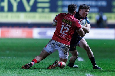 261225 - Scarlets v Ospreys - United Rugby Championship - Dan Edwards of Ospreys is tackled by Johnny Williams of Scarlets