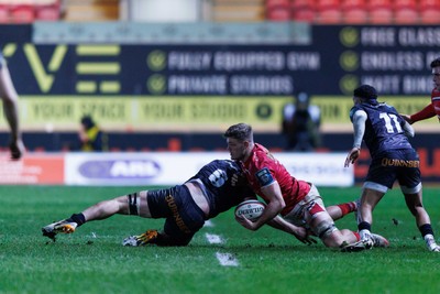 261225 - Scarlets v Ospreys - United Rugby Championship - Taine Plumtree of Scarlets is tackled by James Ratti of Ospreys
