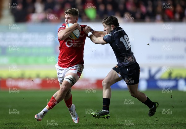 261225 - Scarlets v Ospreys - United Rugby Championship - Taine Plumtree of Scarlets is tackled by Dan Edwards of Ospreys 