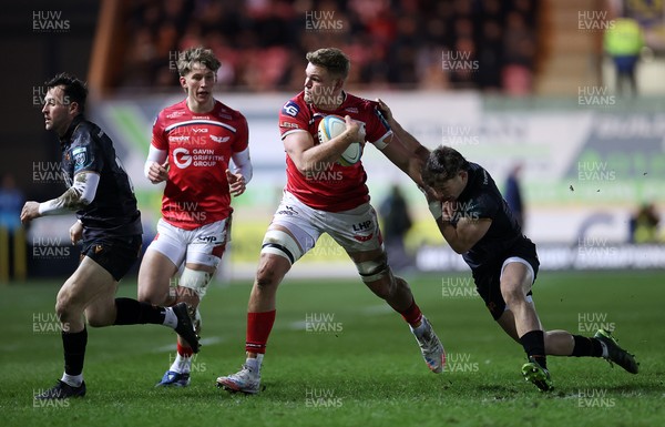 261225 - Scarlets v Ospreys - United Rugby Championship - Taine Plumtree of Scarlets is tackled by Dan Edwards of Ospreys 