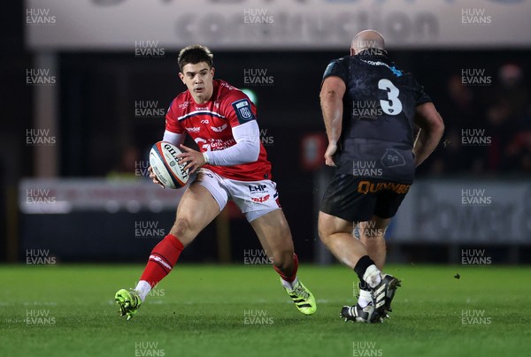 261225 - Scarlets v Ospreys - United Rugby Championship - Joe Hawkins of Scarlets is challenged by Rhys Henry of Ospreys 