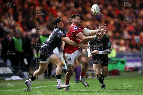 261225 - Scarlets v Ospreys - United Rugby Championship - Johnny Williams of Scarlets is tackled by Owen Watkin of Ospreys 