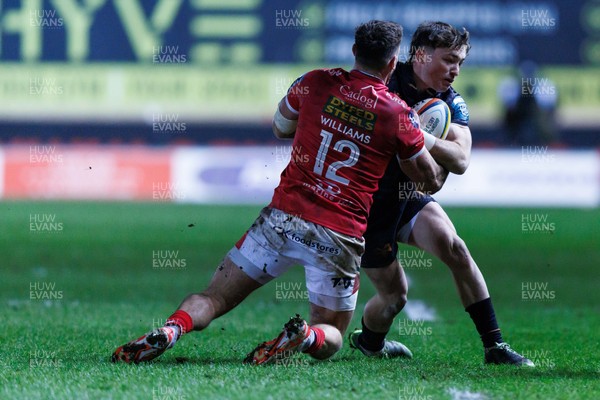 261225 - Scarlets v Ospreys - United Rugby Championship - Dan Edwards of Ospreys is tackled by Johnny Williams of Scarlets