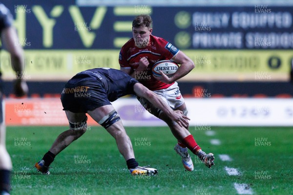 261225 - Scarlets v Ospreys - United Rugby Championship - Taine Plumtree of Scarlets is tackled by James Ratti of Ospreys