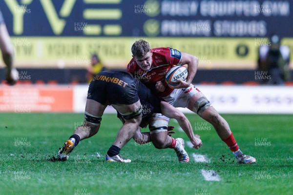 261225 - Scarlets v Ospreys - United Rugby Championship - Taine Plumtree of Scarlets is tackled by James Ratti of Ospreys