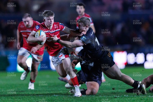 261225 - Scarlets v Ospreys - United Rugby Championship - Archie Hughes of Scarlets is tackled by Keiran Williams of Ospreys