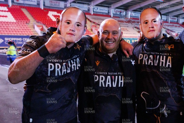 261225 - Scarlets v Ospreys - United Rugby Championship - Rhys Henry of Ospreys (centre) with Sam Parry (L) and Morgan Morris (R) wearing Rhys Henry face masks