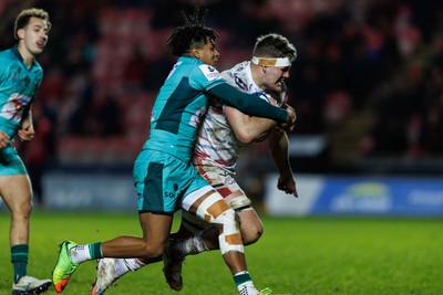100126 - Scarlets v Section Paloise - Investec Champions Cup - Taine Plumtree of Scarlets is tackled by Theo Attissogbe of Pau on the way to scoring a try