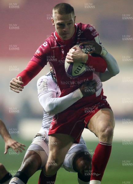 110120 - Scarlets v RC Toloun - European Rugby Challenge Cup - Johnny McNicholl of Scarlets is tackled by Daniel Ikpefan of Toloun