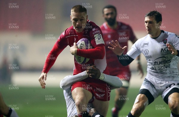 110120 - Scarlets v RC Toloun - European Rugby Challenge Cup - Johnny McNicholl of Scarlets is tackled by Daniel Ikpefan of Toloun