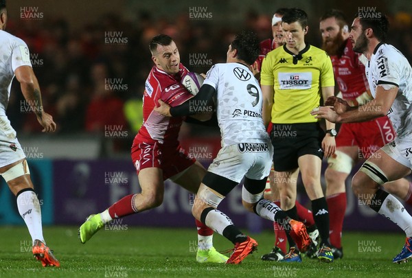110120 - Scarlets v RC Toloun - European Rugby Challenge Cup - Gareth Davies of Scarlets is tackled by Baptiste Serin of Toloun