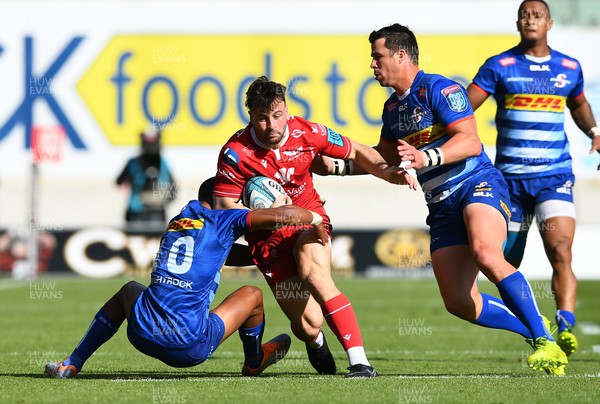 210522 - Scarlets v Stormers - United Rugby Championship - Ryan Conbeer of Scarlets is tackled by Manie Libbok and Ruhan Nel of Stormers