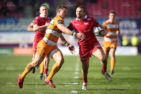 240219 - Scarlets v Toyota Cheetahs - Guinness PRO14 - Paul Asquith of Scarlets is tackled by Tian Schoeman of Cheetahs