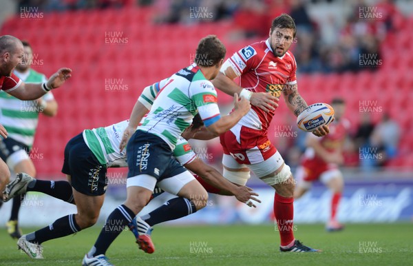 140913 - Scarlets v Treviso - RaboDirect PRO12 -Josh Turnbull of Scarlets is tackled by Luca Morisi of Benetton Treviso