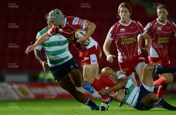 140913 - Scarlets v Treviso - RaboDirect PRO12 -Jonathan Davies of Scarlets is tackled by Matt Berquist of Benetton Treviso