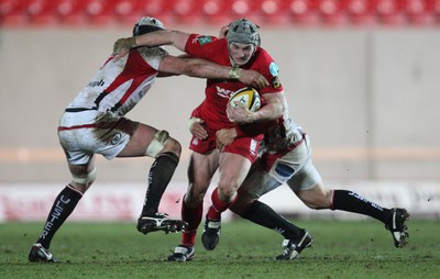 05.03.10 ... Scarlets v Ulster, Magners League -  Scarlets' Jonathan Davies takes on Ulster's Dan Tuohy and BJ Botha  