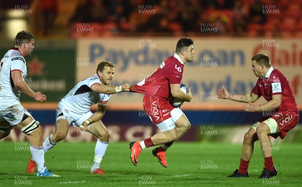 071218 - Scarlets v Ulster - European Rugby Champions Cup - Steff Evans of Scarlets is held by Will Addison of Ulster