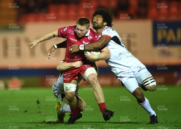 071218 - Scarlets v Ulster - European Rugby Champions Cup - James Davies of Scarlets is tackled by John Cooney and Henry Speight of Ulster