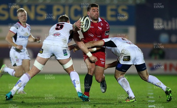 231118 - Scarlets v Ulster - Guinness PRO14 - Kieron Fonotia of Scarlets is tackled by Kieran Treadwell and Michael Lowry of Ulster