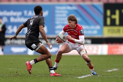240126 - Scarlets v Ulster - United Rugby Championship - Ellis Mee of Scarlets is challenged by Robert Baloucoune of Ulster 