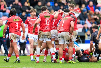 240126 - Scarlets v Ulster - United Rugby Championship - Josh Macleod of Scarlets is congratulated by team mates after winning a turnover