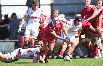 240819 - Scarlets A v Ulster A - Celtic Cup - Efan Jones of Scarlets A is tackled by Azur Allison