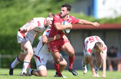 240819 - Scarlets A v Ulster A - Celtic Cup - Rhodri Jones of Scarlets A is tackled by Zack McCall