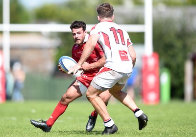 240819 - Scarlets A v Ulster A - Celtic Cup - Rhodri Jones of Scarlets A is tackled by Graham Curtis