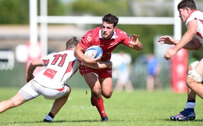 240819 - Scarlets A v Ulster A - Celtic Cup - Rhodri Jones of Scarlets A is tackled by Graham Curtis