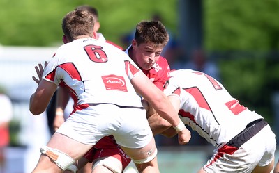 240819 - Scarlets A v Ulster A - Celtic Cup - Lewis Millen of Scarlets A is tackled by Joe Dunleavey and David McCann