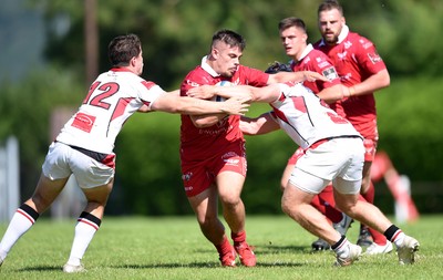 240819 - Scarlets A v Ulster A - Celtic Cup - Dominic Booth of Scarlets A is tackled by Ben Power and Zack McCall