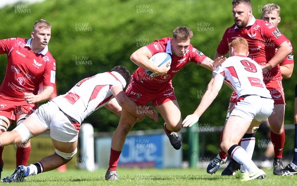 240819 - Scarlets A v Ulster A - Celtic Cup - Kallum Evans of Scarlets A is tackled by David McCann and Nathan Doak